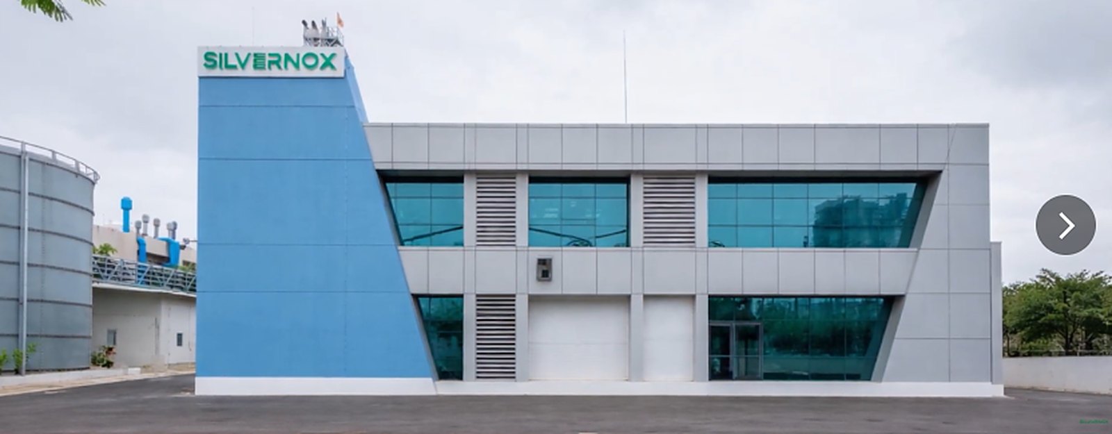 Exterior of the Silvernox Tier III data center facility, showing the elevated cable bridge and blue facade against open sky